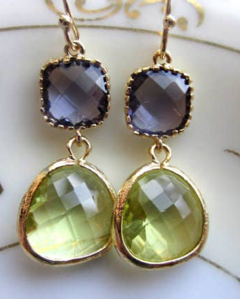 The Peridot Earrings Tanzanite - Gold feature gold-plated earrings with square tanzanite stones on top and larger teardrop-shaped faceted peridot glass gems below.
