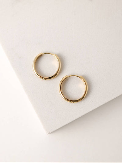 Two gold-plated 20mm hoop earrings with a smooth finish, placed on a neutral background to highlight their simple, timeless design.