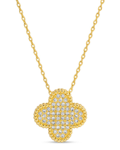 A gold-plated quatrefoil pendant necklace encrusted with sparkling pave cubic zirconia, suspended from a delicate gold chain against a white background.