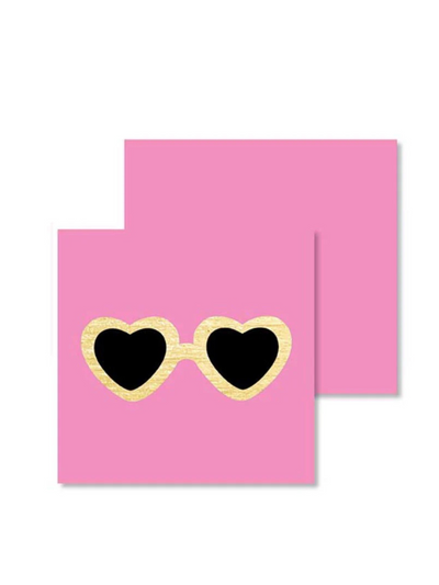 The Heart Glasses Mini - Card showcases a pink background with heart-shaped sunglasses, featuring sleek black lenses and shimmering gold foil frames.