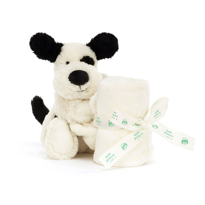 Front view of the Jellycat Bashful Black and Cream Puppy Soother, featuring the soft puppy plush holding the rolled blanket, ready for gifting.