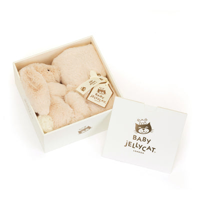 Jellycat Bashful Luxe Bunny Willow Soother: A side view of the Jellycat plush bunny holding the blanket rolled up with a ribbon, highlighting the gift presentation.