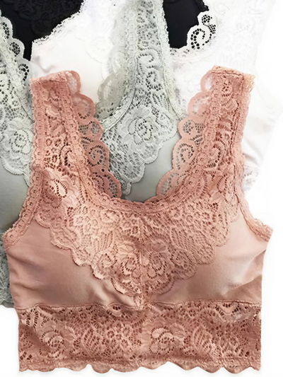 A delicate dusty rose pink bralette featuring an intricate lace design. The bralette has wide lace straps and a scalloped lace trim along the neckline and bottom hem, offering a feminine and elegant style. The body is made of a smooth, satin-like fabric, complementing the lace accents for a soft and comfortable look.