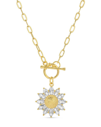 A gold-plated toggle necklace with a sunflower pendant featuring sparkling cubic zirconia petals, suspended from a delicate paperclip chain.