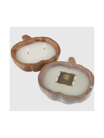 The Wooden Pumpkin Bowl Candle - Small - Fall Chai Tea features two pumpkin-shaped wooden bowls, each filled with white wax and twin wicks to capture the essence of autumn warmth. One candle is adorned with a dark label embellished with gold and white design elements and text, suggesting a delightful cinnamon chai tea fragrance. Both candles are beautifully displayed on a simple white background.